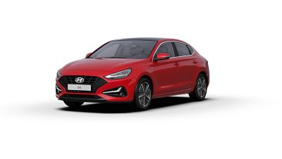 Front side view of the new Hyundai i30 Fastback in the colour Engine Red.
