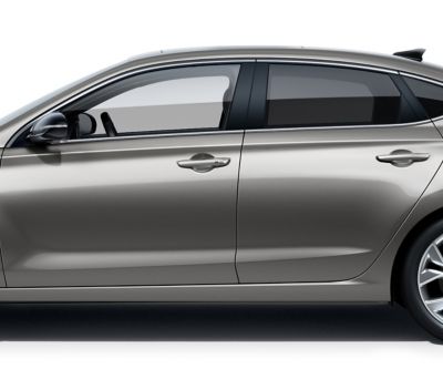 The new Hyundai i30 Fastback pictured from the driver side, focused on the doors roof, windows, and doors