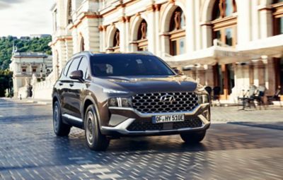 The new Hyundai SANTA FE Plug-in Hybrid 7 seat SUV showing its new full LED headlamps and bumper.