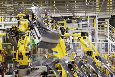 Robotic arms at work in a Hyundai manufacturing facility.